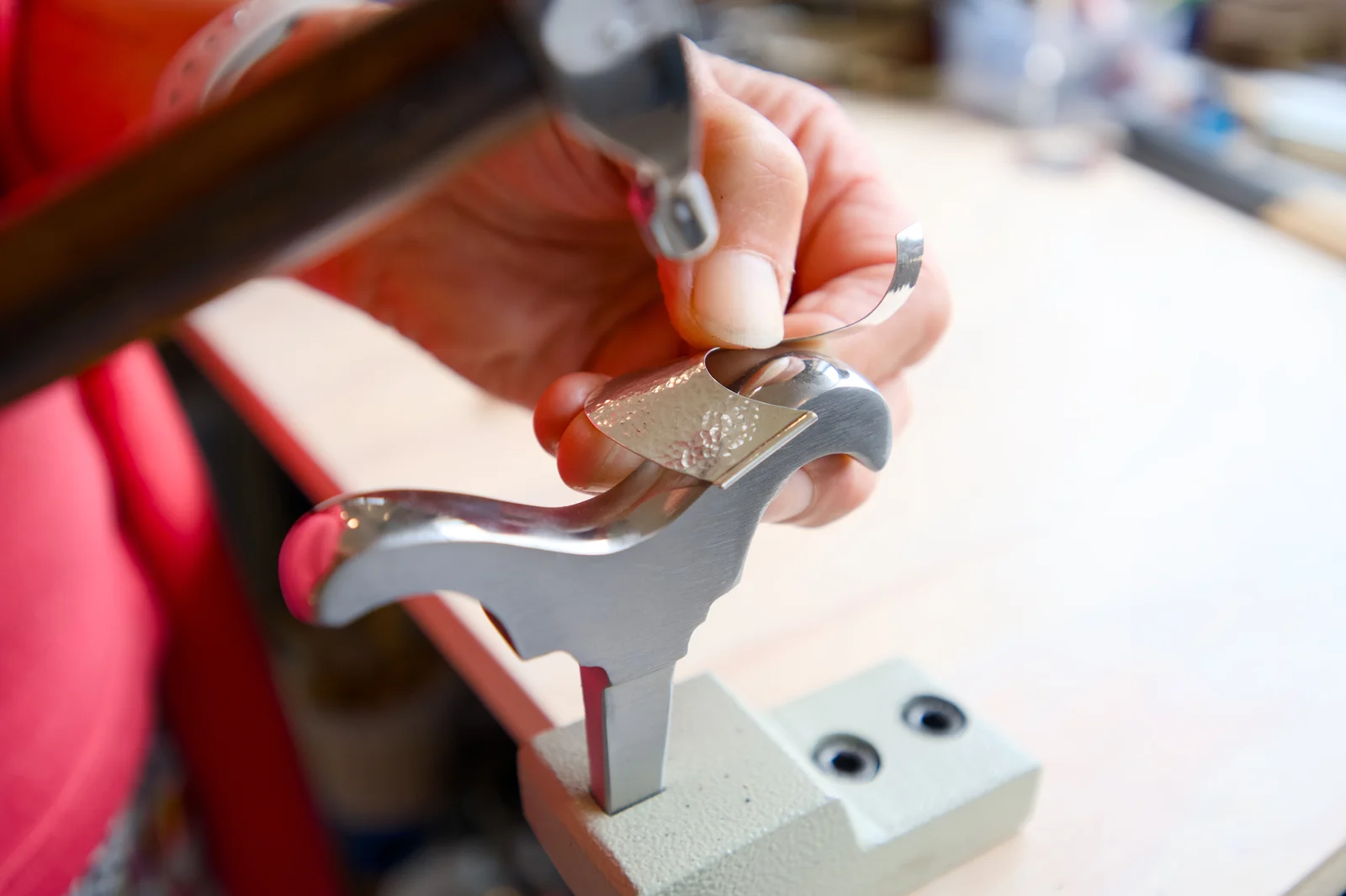 Sue Plumb forging silver at her bench in Blue Range Studio